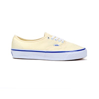 Light off-white sneaker with blue sole on a white background