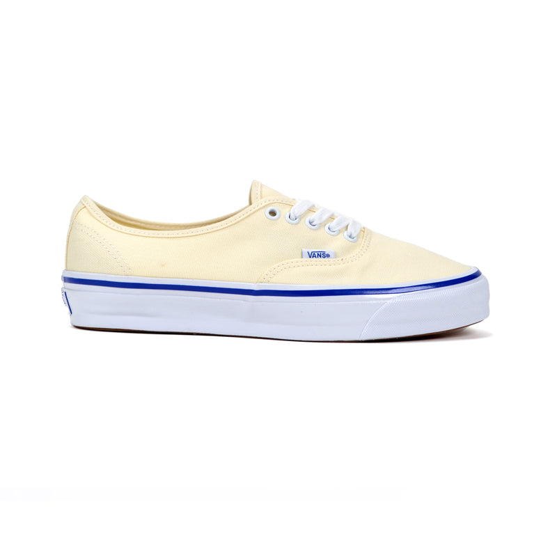 Light off-white sneaker with blue sole on a white background