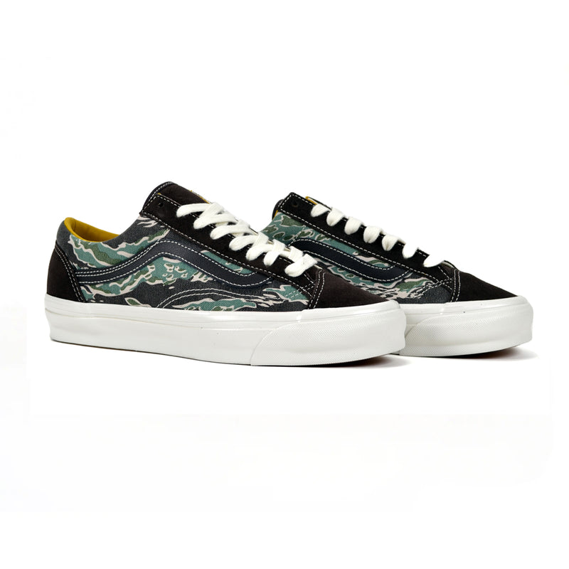 Pair of black sneakers with camouflage pattern on a white background