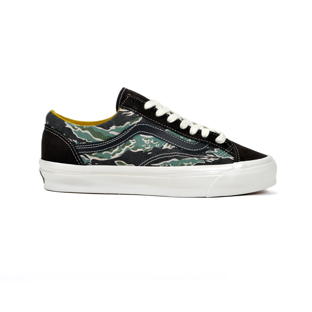 Black sneaker with green camouflage pattern on a white background