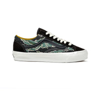 Black sneaker with green camouflage pattern on a white background