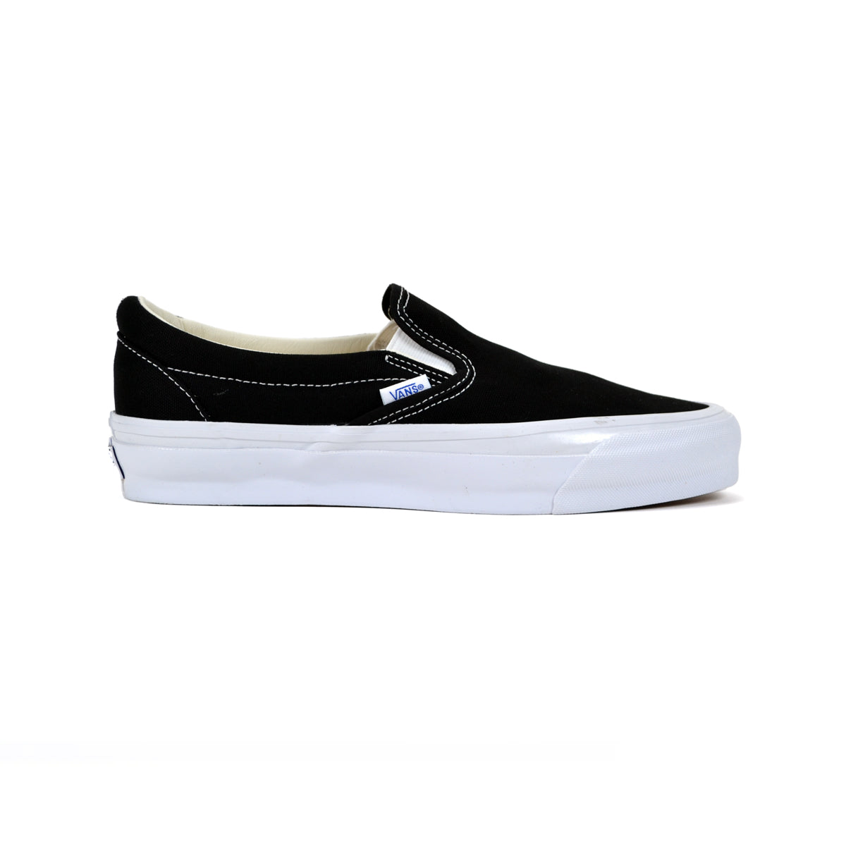 Black slip-on sneaker with white sole on a white background