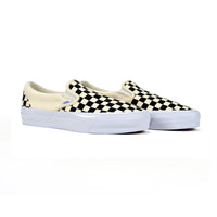 Pair of checkered slip-on sneakers on a white background