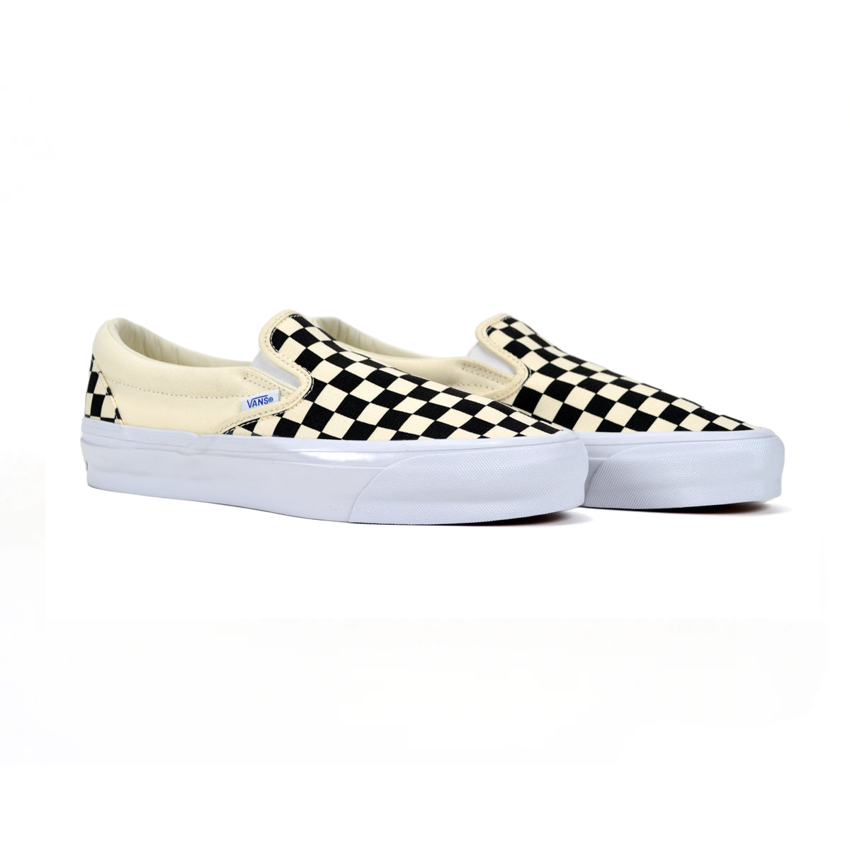 Pair of checkered slip-on sneakers on a white background