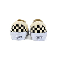 Pair of Vans shoes with checkered soles on a white background