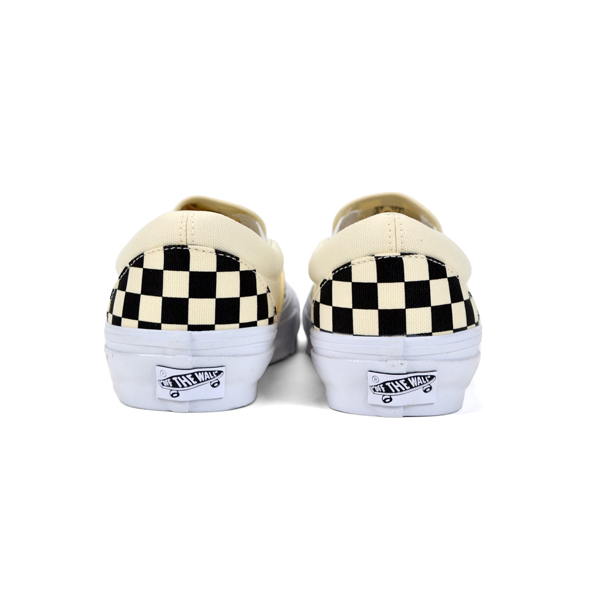 Pair of Vans shoes with checkered soles on a white background